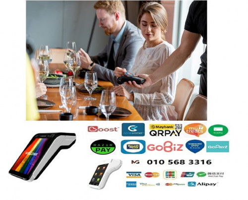 Businesswoman paying by credit card on terminal held by the waiter in sushi bar