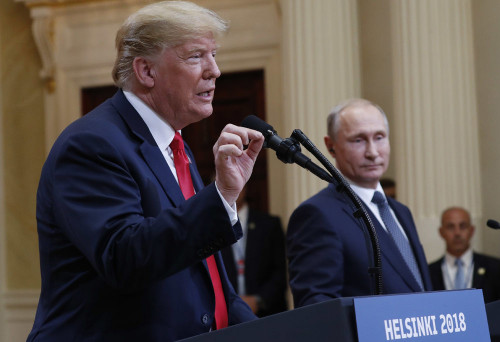 U.S. President Donald Trump, left, gestures while speaking as Russian President Vladimir Putin, righ